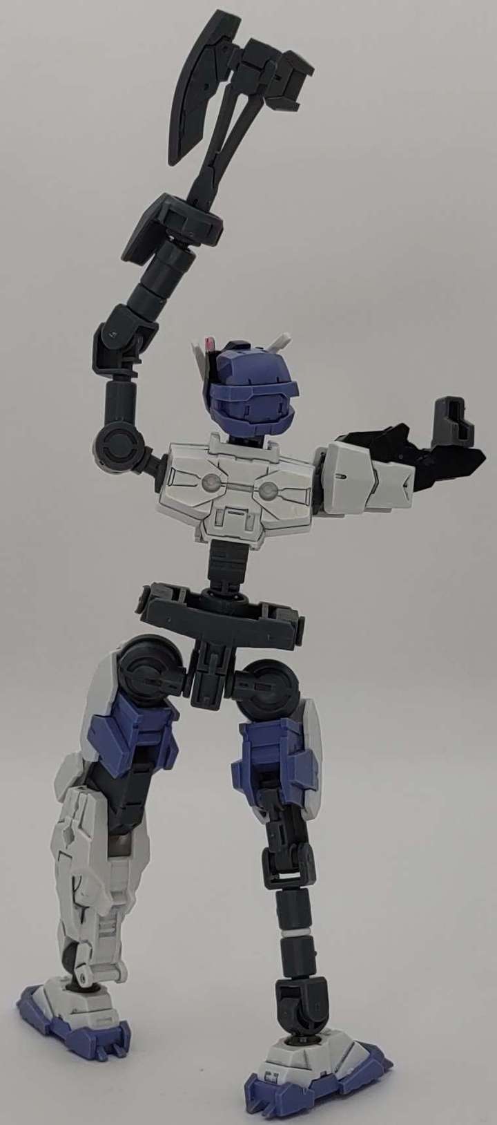 Victory pose with axe arm held high, rear view